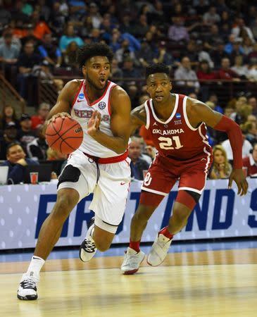 Mar 22, 2019; Columbia, SC, USA; Mississippi Rebels guard Blake Hinson (0) drives around Oklahoma Sooners forward Kristian Doolittle (21) during the second half in the first round of the 2019 NCAA Tournament at Colonial Life Arena. Mandatory Credit: Bob Donnan-USA TODAY Sports