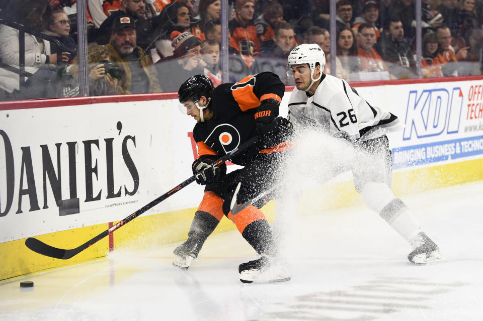 Philadelphia Flyers' Travis Konecny, left, controls the puck in front of Los Angeles Kings' Sean Walker during the second period of an NHL hockey game, Saturday, Jan. 18, 2020, in Philadelphia. (AP Photo/Derik Hamilton)