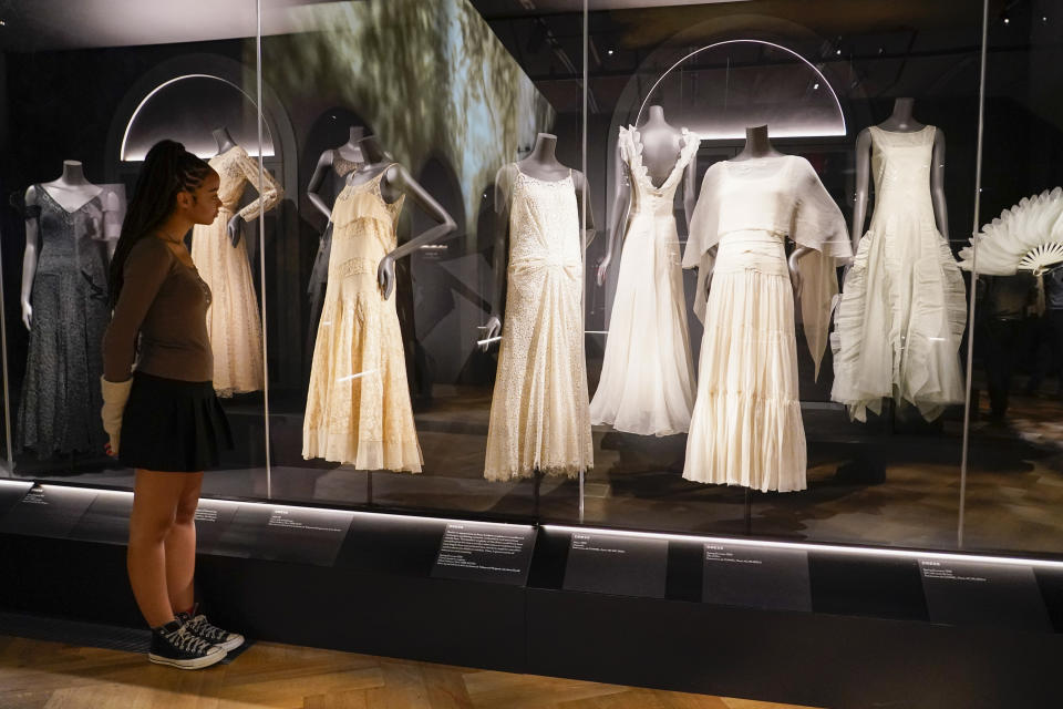 A curator poses next to creations which are displayed as part of the "Gabrielle Chanel. Fashion Manifesto" exhibition at the Victoria and Albert museum, in London, Tuesday, Sept. 12, 2023.(AP Photo/Alberto Pezzali)