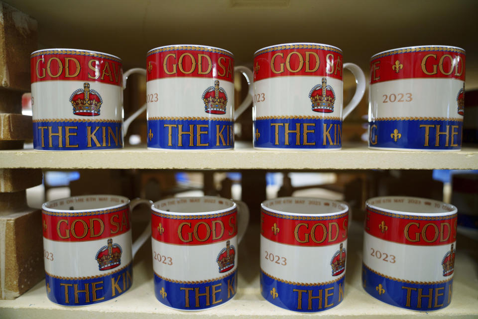 Mugs are lined up for the kiln, at the Duchess China 1888 factory, in Stoke-on-Trent, England, Thursday, March 30, 2023. With just five weeks to go until King Charles III’s coronation, an historic pottery is busy producing “God Save The King” commemorative china plates and mugs to mark the occasion. (AP Photo/Jon Super)