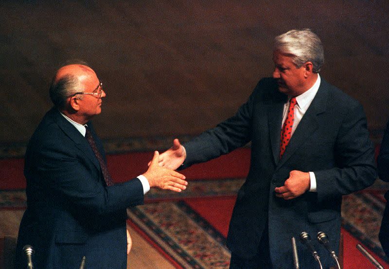 FILE PHOTO: Soviet President Gorbachev shakes hands with Russian President Yeltsin in Russian Parliament