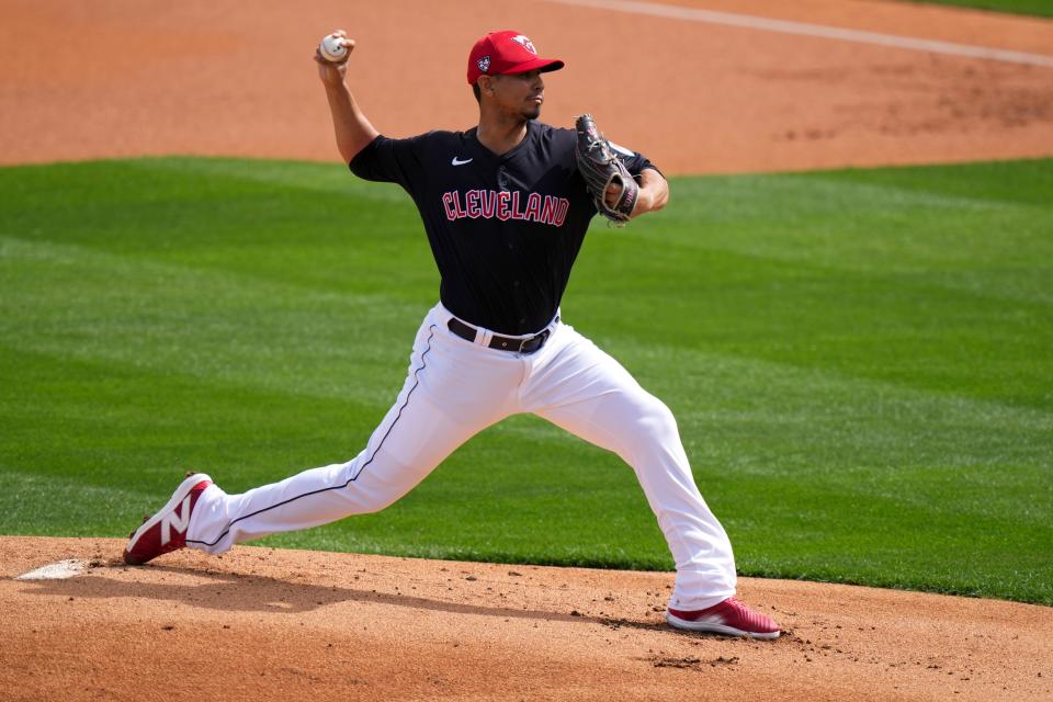 Cleveland Guardians pitcher Carlos Carrasco delivers a pitch in the first inning during a MLB spring training baseball game against the Cincinnati Reds, Saturday, Feb. 24, 2024, at Goodyear Ballpark in Goodyear, Ariz.