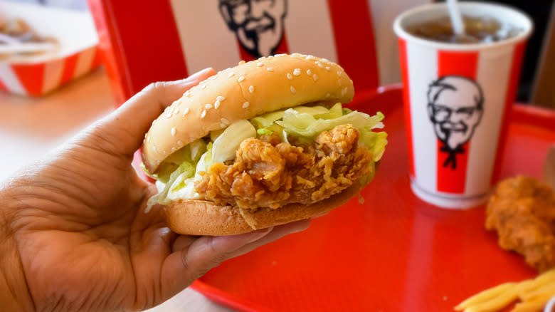 Hand holding KFC chicken sandwich