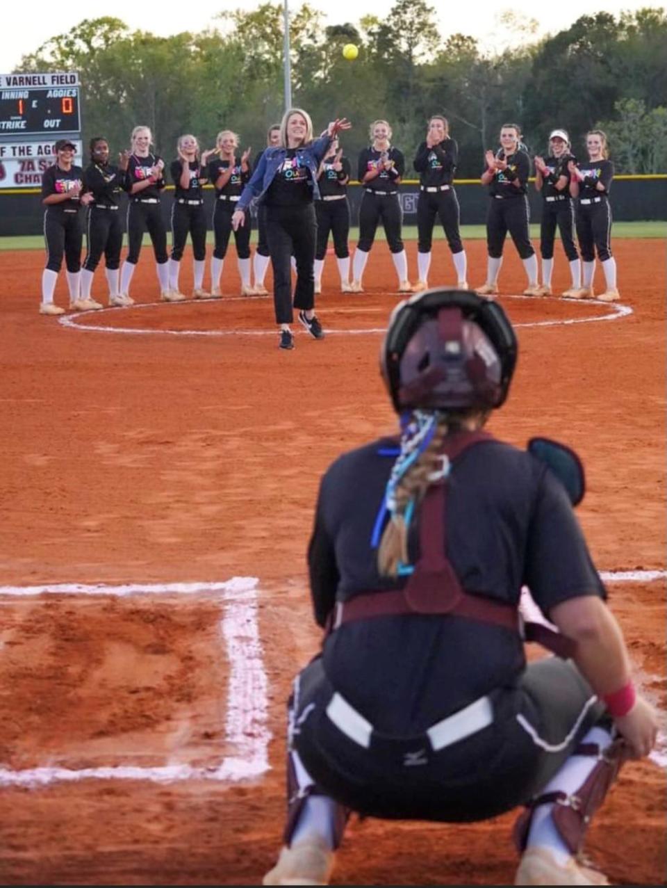 Tate principal Laura Touchstone throws out the 2022 Strike Out Cancer game's first pitch.