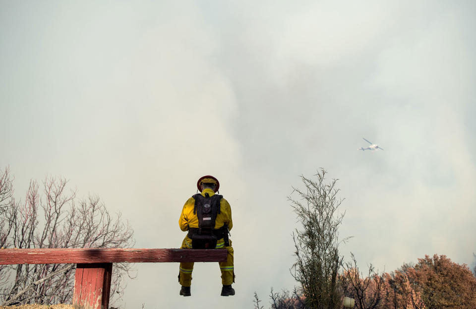 <p>Firefighter Capt. Chris Zinko takes a break while battling a wildfire near Morgan Hill, Calif., on Tuesday, Sept. 27, 2016. A heat wave stifling drought-stricken California has worsened a wildfire that burned some buildings and forced people from their homes in remote communities along the Santa Cruz Mountains. (AP Photo/Noah Berger) </p>