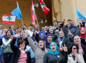 Supporters of Saad al-Hariri, who suspended his decision to resign as prime minister, hold flags and chant slogans near Martyrs' Square in downtown Beirut, Lebanon November 22, 2017. REUTERS/Jamal Saidi