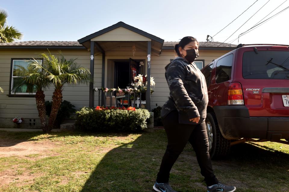 Delma Mendez, a Nyeland Acres mother of three, walks past the front of her Almond Drive home on Jan. 25 after an internet antenna was installed for her youngest child. The nonprofit Nyeland Promise recently installed several internet towers and antennas throughout the unincorporated neighborhood near Oxnard to provide free internet access to 132 households of Rio School District children.