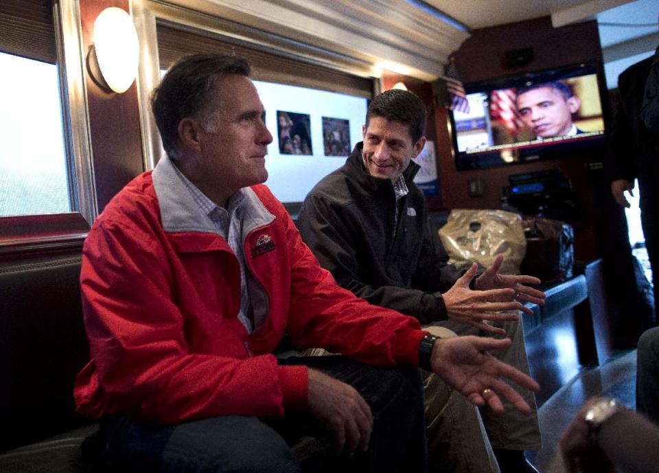 Republican presidential candidate, former Massachusetts Gov. Mitt Romney, right, talks with his vice presidential running mate Rep. Paul Ryan, R-Wis., on his campaign bus after a rally on Tuesday, Sept. 25, 2012 in Vandalia, Ohio. (AP Photo/ Evan Vucci)