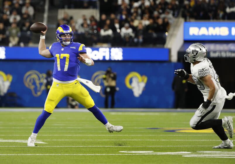 Rams quarterback Baker Mayfield finds an open receiver while scampering away from Las Vegas Raiders linebacker Luke Masterson