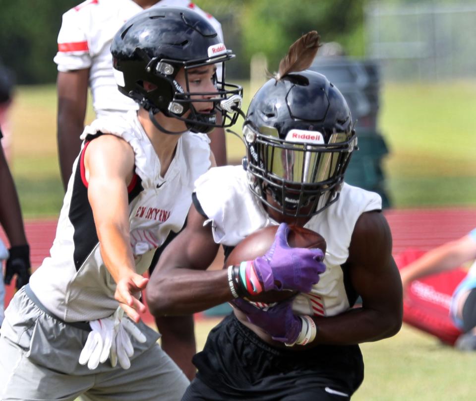 New Smyrna Beach high's Jvontae Hayward #10 takes a handoff from GB Bryant Siravo #8, Wednesday April 27, 2022 as the team runs drills in practice.