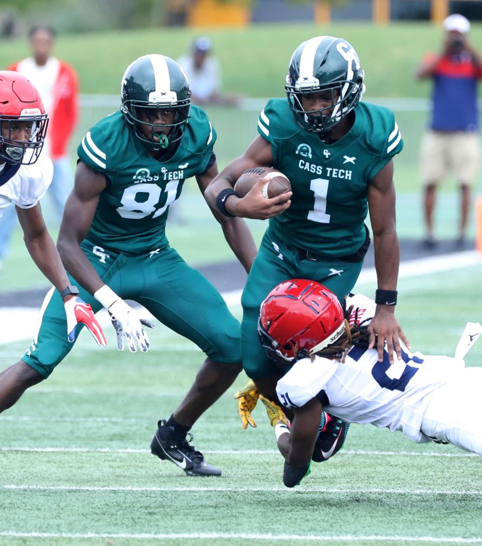 Cass Tech quarterback Corey Sadler Jr. is tackled by Southfield A&T defensive back Shamarion Flemming during first half action Saturday, August 26, 2023.