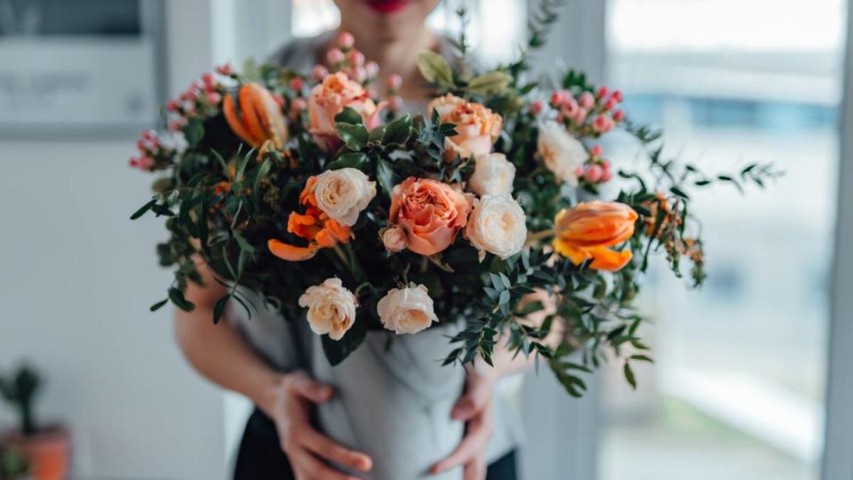 uses for sugar: Shot of an unrecognisable woman covering her face with flowers in living room