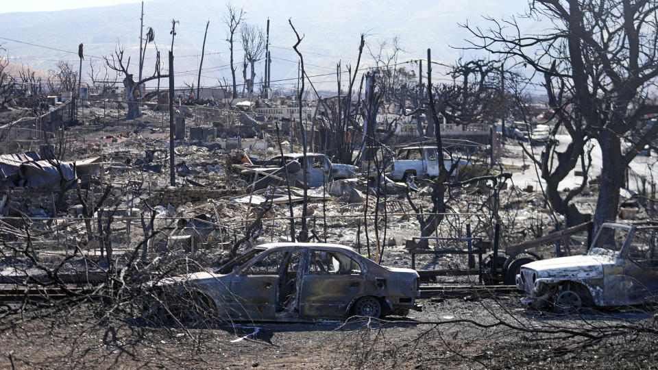 Destroyed homes and cars are shown, Sunday, Aug. 13, 2023, in Lahaina, Hawaii. (AP Photo/Rick Bowmer)