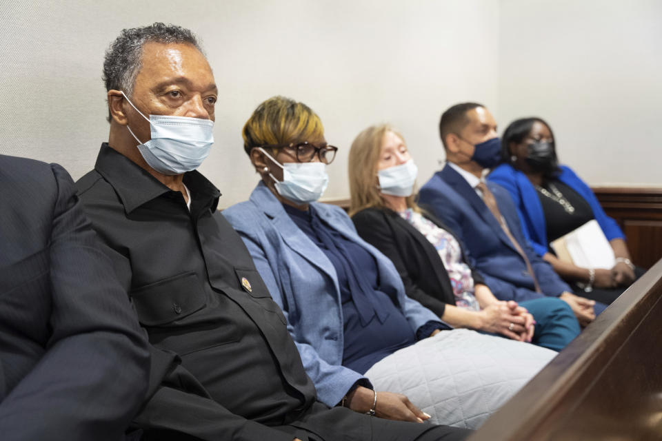 Rev. Jesse Jackson, left, sits with Wanda Cooper-Jones, mother of Ahmaud Arbery, during the trial of Arbery at the Glynn County Courthouse on Thursday, Nov. 18, 2021 in Brunswick, Ga. Travis McMichael, his father Greg McMichael, and a neighbor William "Roddie" Bryan are charged charged with the February 2020 slaying of 25-year-old Ahmaud Arbery. (Sean Rayford/Pool Photo via AP)