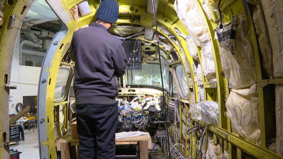 A technician helps turn a Beechcraft 1900 D airplane into an air ambulance at the EVAS Air MRO (maintenance, repair and overhaul) in Ganader.