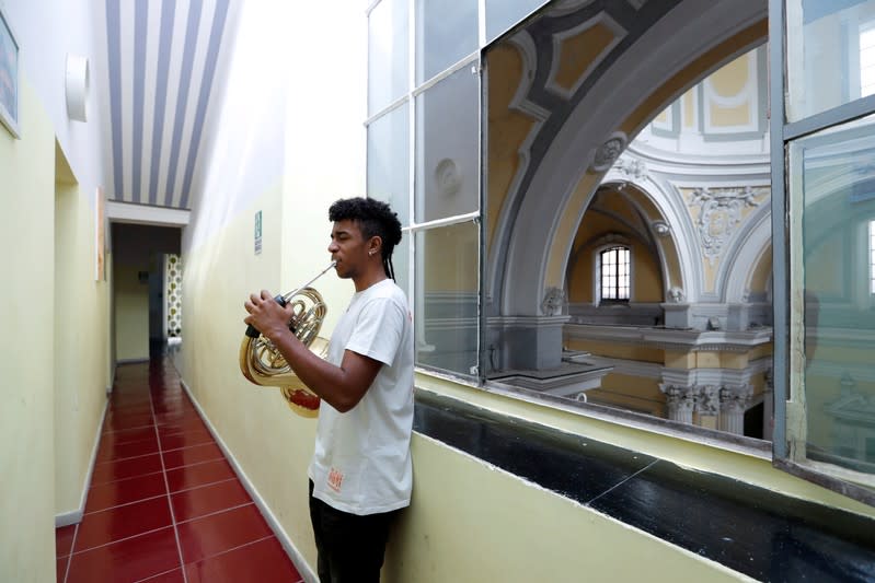 Nico Rodrigues, 21, practises on his French horn in Saint Severo Out of Walls church, close to the Santa Maria della Sanita Basilica in the Rione Sanita neighbourhood in Naples