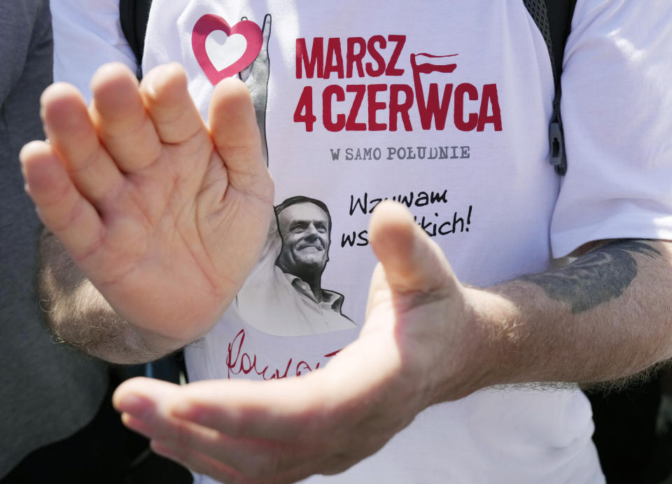 A person applauds during anti-government march led by the centrist opposition party leader Donald Tusk, who along with other critics accuses the government of eroding democracy, in Warsaw, Poland, Sunday, June 4, 2023. Poland's largest opposition party led a march Sunday meant to mobilize voters against the right-wing government, which it accuses of eroding democracy and following Hungary and Turkey down the path to autocracy. The march is being held on the 34th anniversary of the first partly free elections, a democratic breakthrough in the toppling of communism across Eastern Europe. (AP Photo/Czarek Sokolowski)