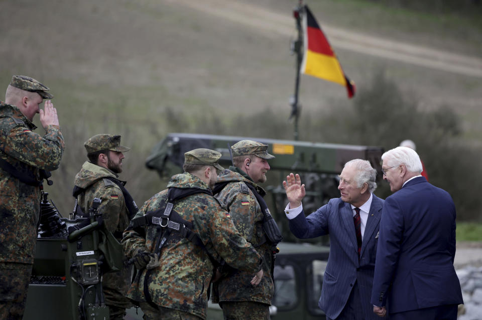 FILE - Britain's King Charles III, 2nd right, talks with soldiers during his visit at the 130th German-British Pioneer Bridge Battalion military unit in Finowfurt, eastern Germany, on Thursday, March 30, 2023. King Charles III won plenty of hearts during his three-day visit to Germany, his first foreign trip since becoming king following the death of his mother, Elizabeth II, last year. (Jens Schlueter /Pool Photo via AP, File)