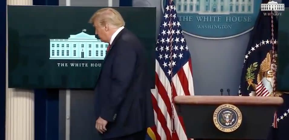 President Trump is escorted from the White House press briefing room Monday, shortly after starting a news conference. (HuffPost)