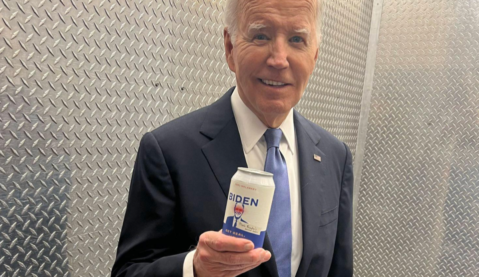 President Joe Biden poses with a can of water on June 27 mocking Donald Trump’s unsubstantiated claims that the president is using performance-enhancing drugs (Biden campaign)