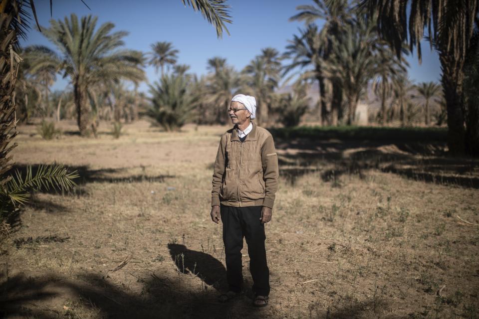 Hassan Bouazza poses for a portrait at his land, in the Alnif oasis town, near Tinghir, Morocco, Tuesday, Nov. 29, 2022. He was the first to install solar panels on the region’s ksar, or castle, and began relying on the energy produced to dig wells and irrigate his fellow farmers’ lands. (AP Photo/Mosa'ab Elshamy)