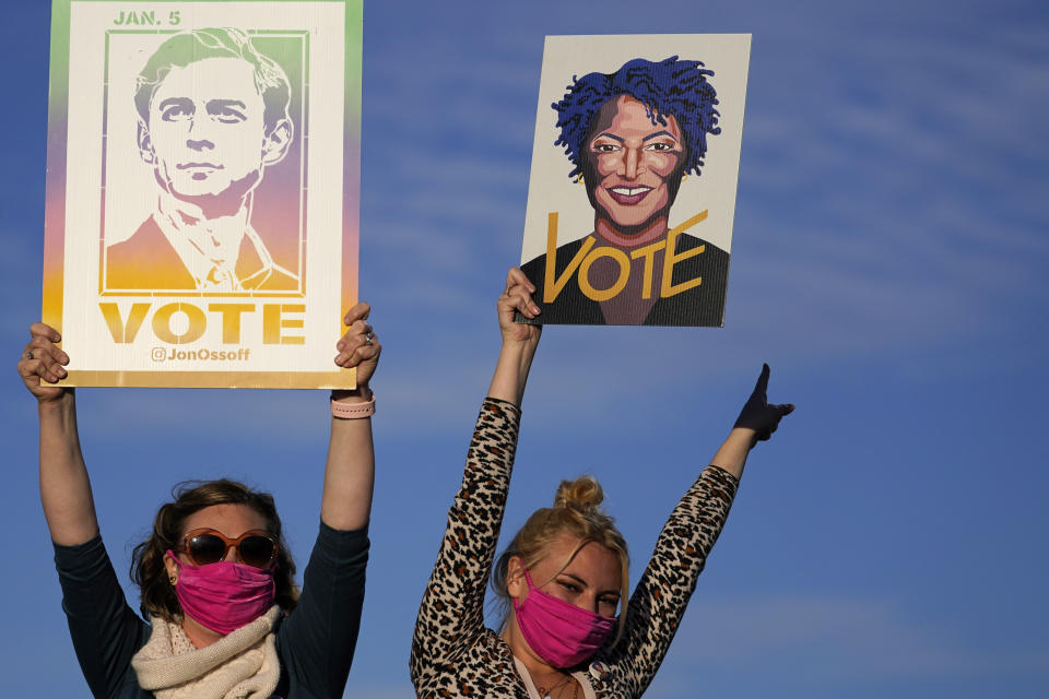 Supporters listen as President-elect Joe Biden speaks in Atlanta, Monday, Jan. 4, 2021, as he campaigns for Senate candidates Raphael Warnock and Jon Ossoff. (AP Photo/Carolyn Kaster)