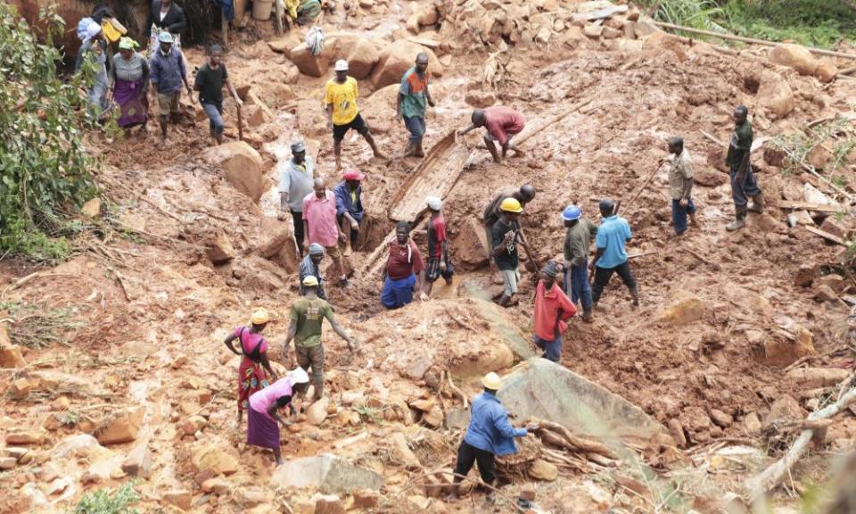 A family dig for their son, who was buried in mud when Cyclone Idai struck Chimanimani in Zimbabwe.