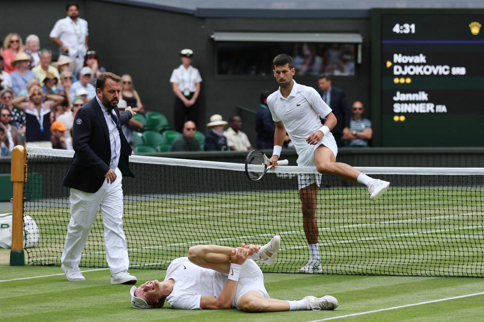 Novak Djokovic (pictured right) crosses over the net tin concern to help Jannik Sinner (pictured middle) at Wimbledon.