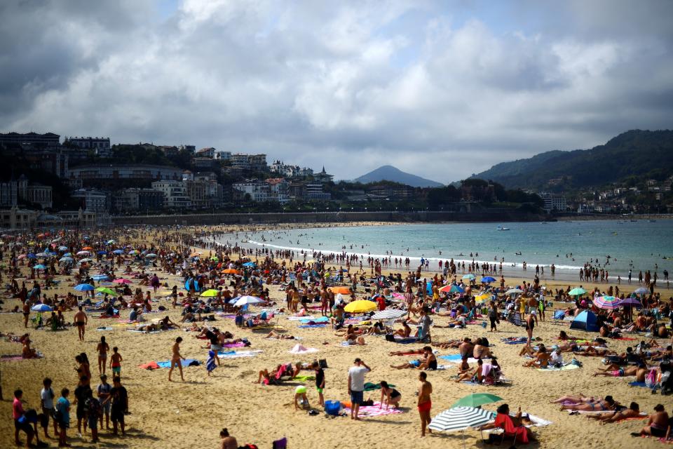 People sunbathe on a sunny day at La Concha beach in the Spanish Basque city of San Sebastian on September 16, 2018. Photo: GABRIEL BOUYS/AFP/Getty Images