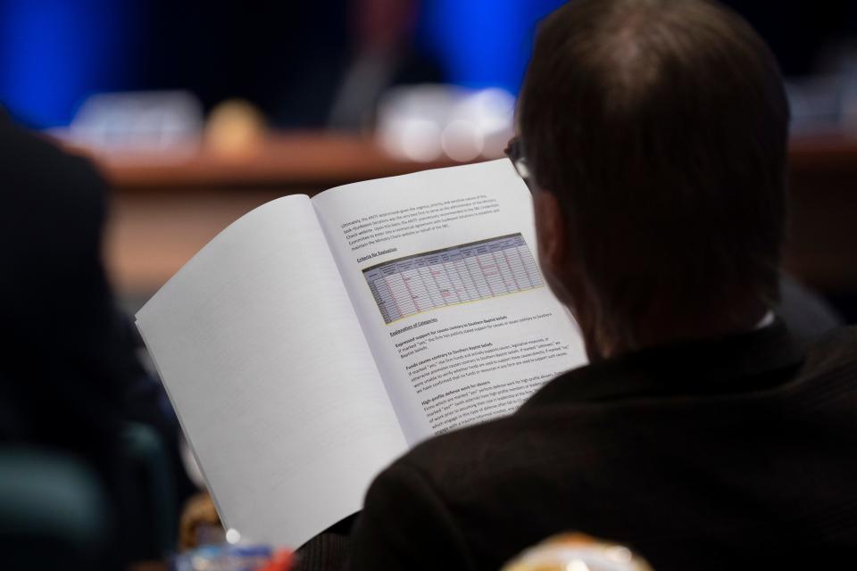An executive committee member of the Southern Baptist Convention looks over a report from the Abuse Reform Implementation Task Force during their meeting Monday, Feb. 20, 2023 in Nashville, Tenn.