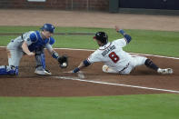 Los Angeles Dodgers catcher Will Smith can not make the tag on Atlanta Braves' Eddie Rosario scores on a single by Ozzie Albies in the eighth inning in Game 2 of baseball's National League Championship Series Sunday, Oct. 17, 2021, in Atlanta. (AP Photo/John Bazemore)