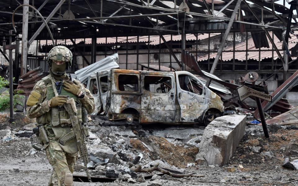 A Russian serviceman patrols the destroyed part of the Ilyich Iron and Steel Works in Ukraine's port city of Mariupol - OLGA MALTSEVA /AFP