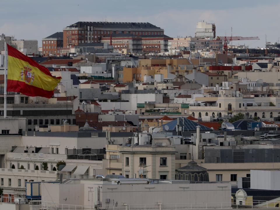 FILE PHOTO: A Spanish flag flutters over buildings in Madrid, Spain June 4, 2018. REUTERS/Sergio Perez/File Photo