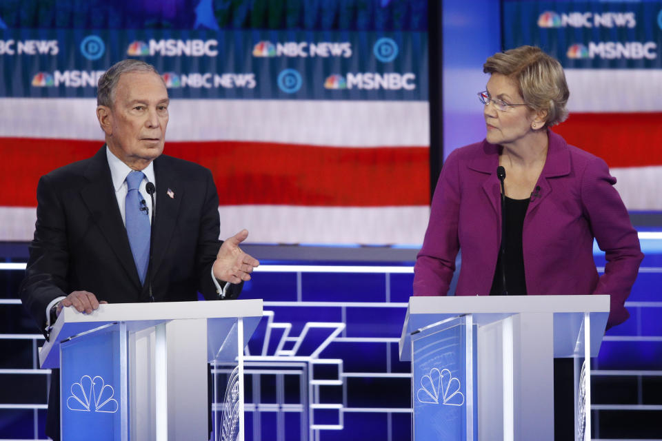 Mike Bloomberg, left, speaks as Sen. Elizabeth Warren looks on during the Democratic presidential primary debate in Las Vegas on Wednesday. (AP Photo/John Locher)