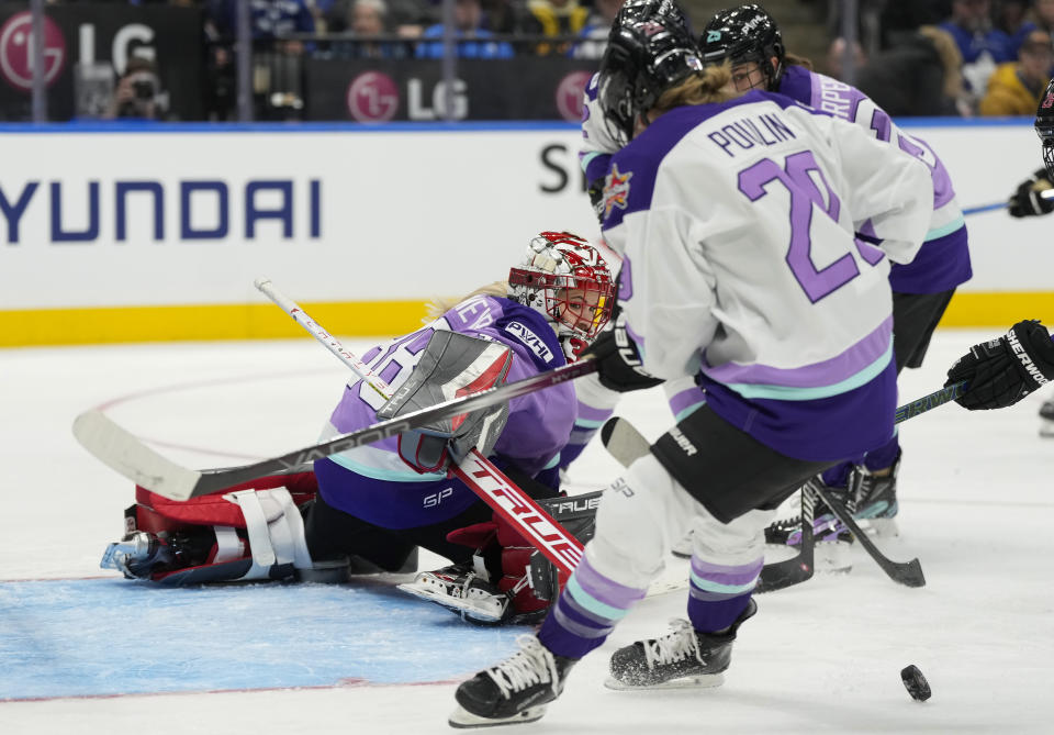 Team Kloss goalie Emerance Maschmeyer, left, makes a save as Team King's Marie-Philip Poulin (29) looks for the rebound during the PWHL 3-on-3 Showcase at the NHL All-Star hockey week in Toronto on Thursday, Feb. 1, 2024. (Frank Gunn/The Canadian Press via AP)