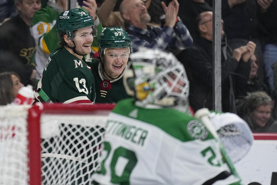 Minnesota Wild left wing Kirill Kaprizov (97) celebrates with center Sam Steel, left, after scoring a goal against Dallas Stars goaltender Jake Oettinger during the first period of an NHL hockey game Thursday, Dec. 29, 2022, in St. Paul, Minn. (AP Photo/Abbie Parr)