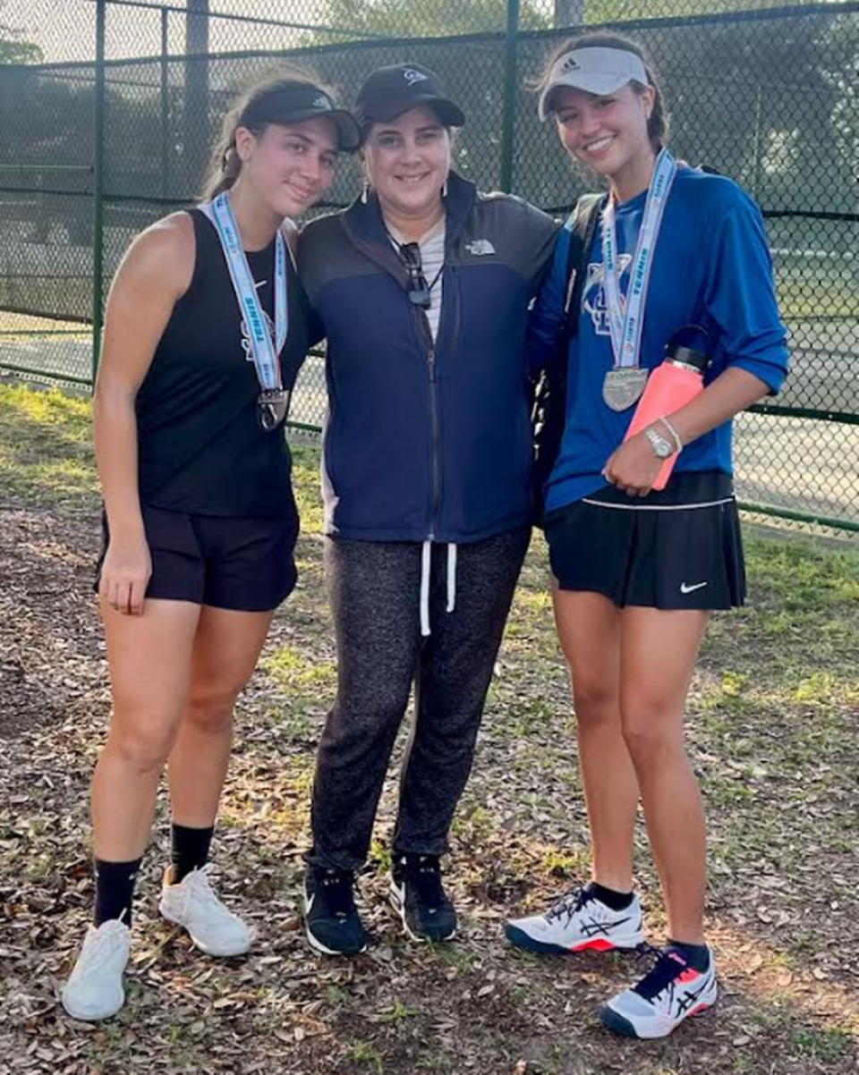 Avril Rodriguez and Cata Kettlewell of the Divine Savior girls’ tennis team reached the overall finals at No.1 doubles in Class 1A of the FHSAA State Tennis Championships. Also pictured is Coach Jenny Sotomayor.