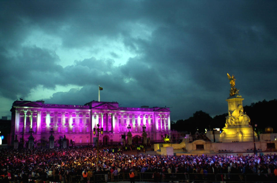 Coloured lights change the appearance of the facade of Buckingham Palace in London commemorate Britain's Queen Elizabeth's Golden Jubilee. Earlier, some 12,000 people had watched the Party in the Palace - the second concert to be held in the grounds in three days.  *    and a crowd estimated by police as up to one million strong gathered outside to enjoy the music.  On Tuesday she will travel to the St Paul's for a service of thanksgiving.   (Photo by David Cheskin - PA Images/PA Images via Getty Images)