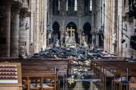 Charred material from the roof litters the floor of the church, where rows of wooden pews still stand.