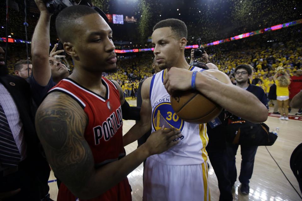 Stephen Curry (right) talks with Damian Lillard after the Warriors eliminated the Blazers from the 2016 NBA playoffs. (AP/Marcio Jose Sanchez)