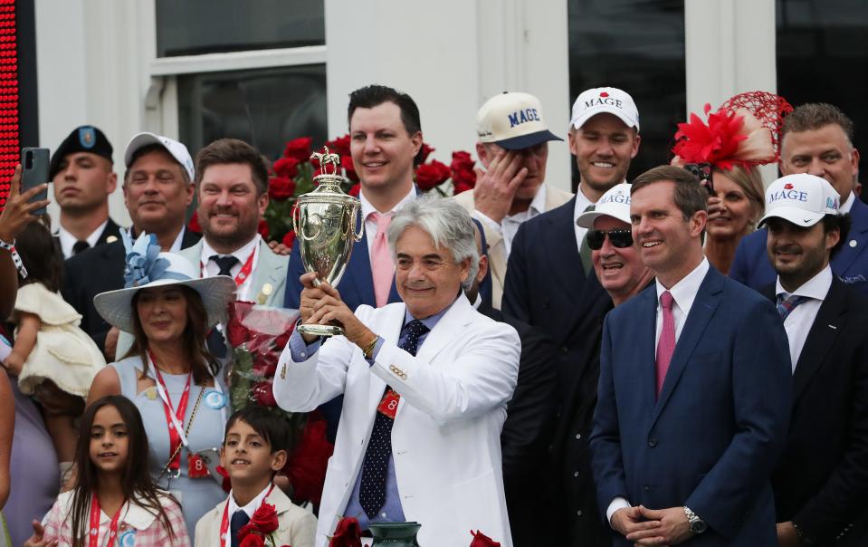 Mage trainer Gustavo Delgado, Sr. hoisted the winning trophy in the winner's circle after his team won Kentucky Derby at Churchill Downs in Louisville, Ky. on May 6, 2023.