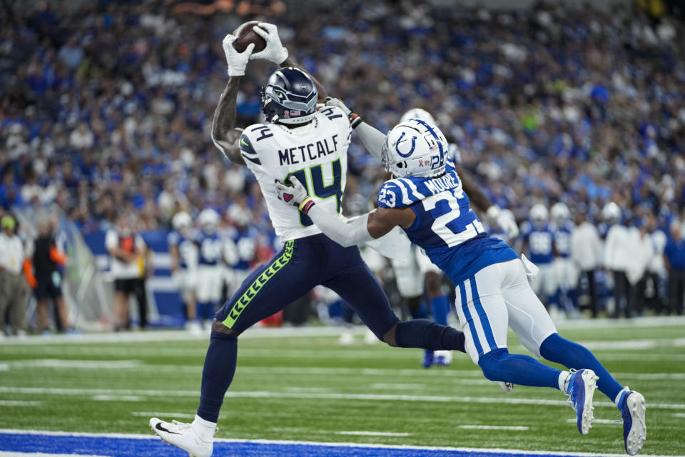 Seattle Seahawks wide receiver DK Metcalf (14) makes a catch in front of Indianapolis Colts cornerback Kenny Moore II (23) for a touchdown during the second half of an NFL football game in Indianapolis, Sunday, Sept. 12, 2021. (AP Photo/AJ Mast)