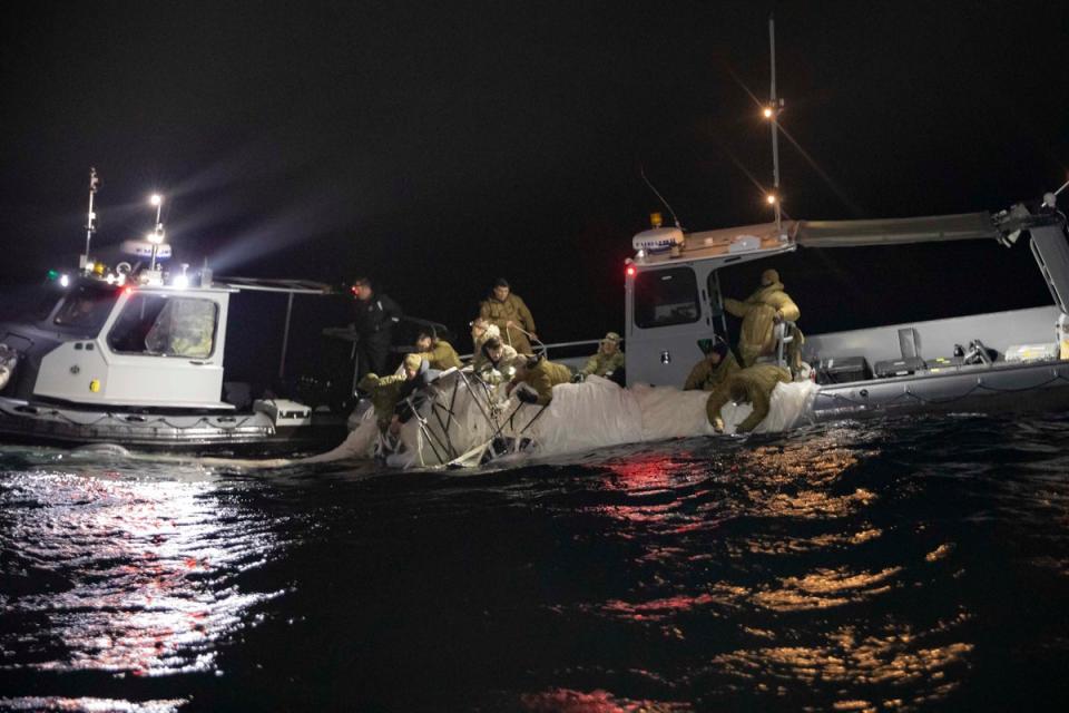 Spy balloon recovery: An image released by the US Navy shows sailors with the Explosive Ordnance Disposal Group recover what the Pentagon has described as a “high-altitude surveillance balloon” off the coast of Myrtle Beach, South Carolina, Feb. 5, 2023. (Image supplied by US Navy / 1st Class Tyler Thompson )