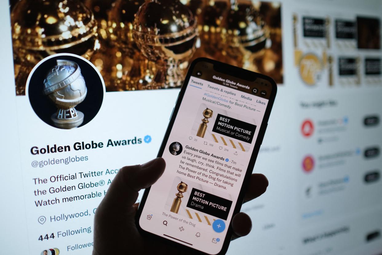 This illustration photo shows a person checking the Golden Globe Awards online via the Golden Globes Twitter account, in Los Angeles, January 9, 2022. - 