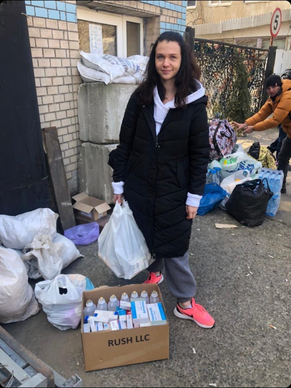 Kate Kondakova surrounded by bags and boxes of medicine that 3DLook employees volunteered to help provide for Ukrainian defenders.