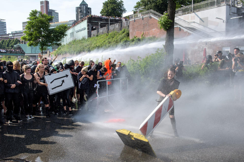 Police use water cannons against protesters.&nbsp;