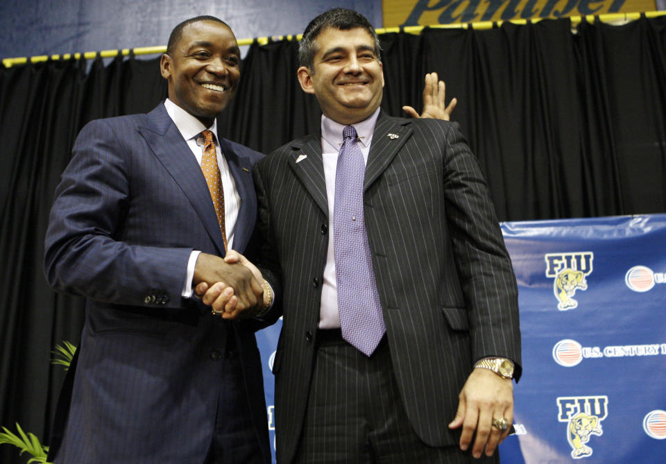 Isiah Thomas, left, shakes hands with Florida International athletic director Pete Garcia, right, following a news conference that introduced Thomas as the new men's college basketball coach at FIU, Wednesday, April 15, 2009, in Miami. (AP Photo/Lynne Sladky)