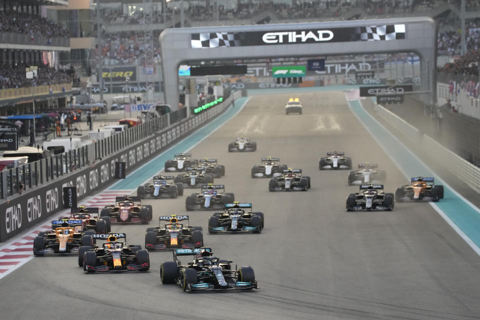 Mercedes driver Lewis Hamilton of Britain leads at the start the Formula One Abu Dhabi Grand Prix in Abu Dhabi, United Arab Emirates, Sunday, Dec. 12. 2021. (AP Photo/Hassan Ammar)