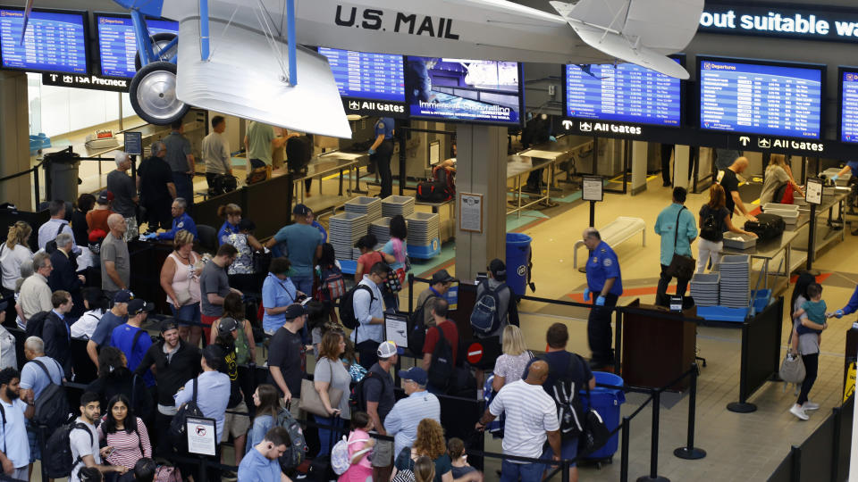 In this June 9, 2019, file photo, travelers make their way through a TSA security checkpoint in Pittsburgh International's Landside terminal in Imperial, Pa. The Transportation Security Administration said Thursday, July 11, 2019, that its officers screened 2,795,014 passengers and airline crew members on Sunday, July 7, barely beating a record set just five weeks earlier, over the Memorial Day weekend. (AP Photo/Gene J. Puskar, File)