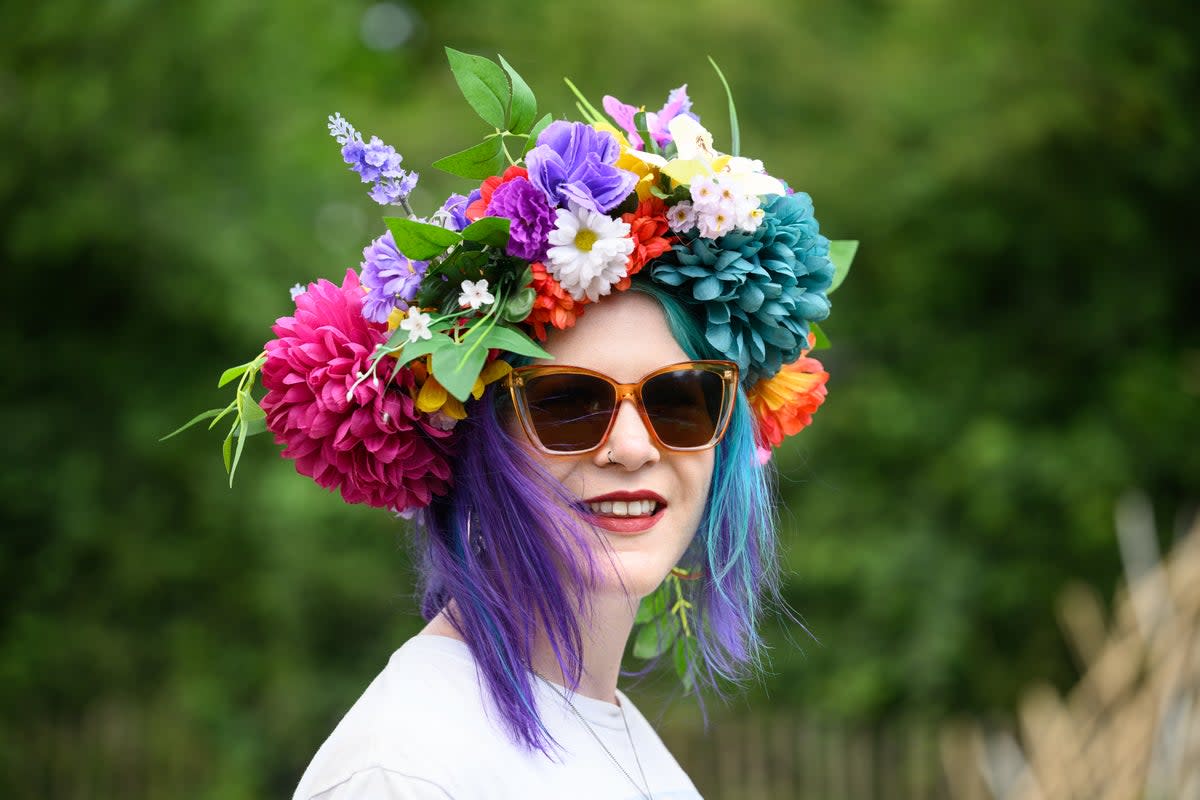 Pat Watling from the Isle of Man poses for a photo wearing her homemade floral hat on day one of Glastonbury Festival 2023 (Getty Images)